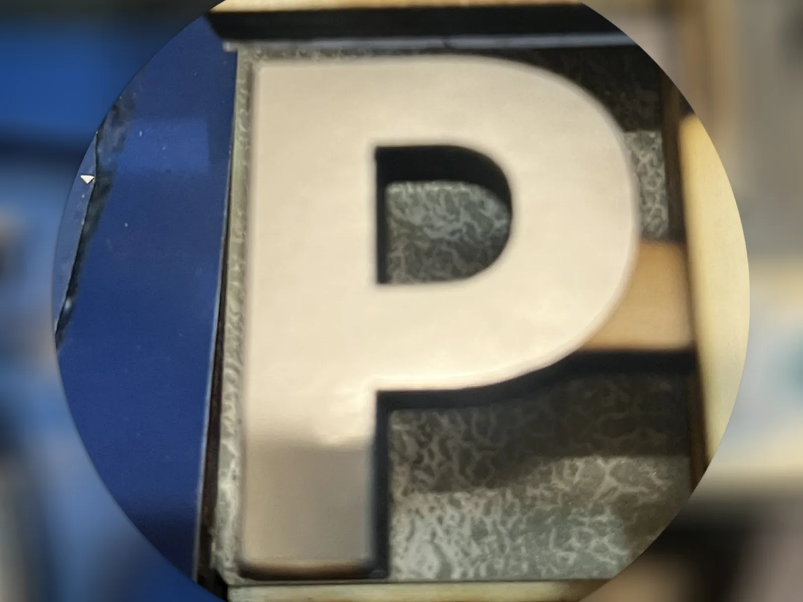 Close-up of a metal P initial used for the P edition